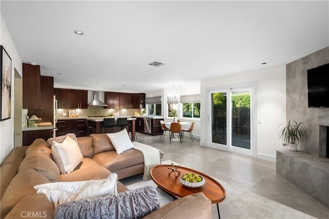 26356 Sorrell Pl, Laguna Hills, CA 92653 - living area with finished concrete flooring, a fireplace, and recessed lighting