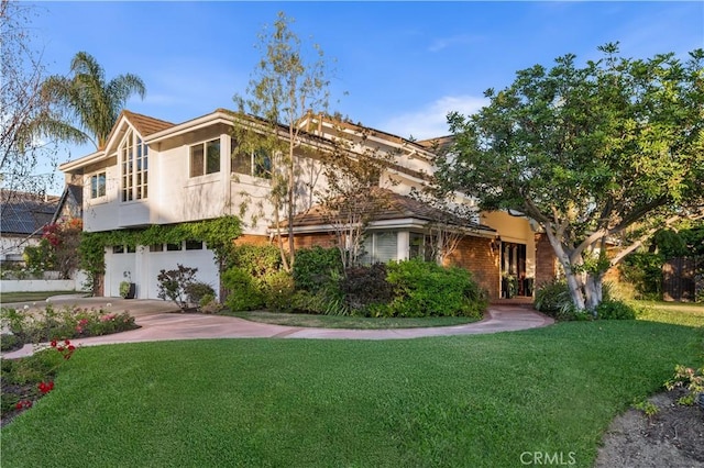 26356 Sorrell Pl, Laguna Hills, CA 92653 - view of front facade with a front lawn, a garage, driveway, and stucco siding