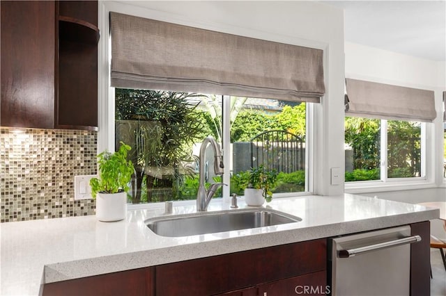 26356 Sorrell Pl, Laguna Hills, CA 92653 - kitchen featuring dishwasher, backsplash, light stone countertops, and dark brown cabinets