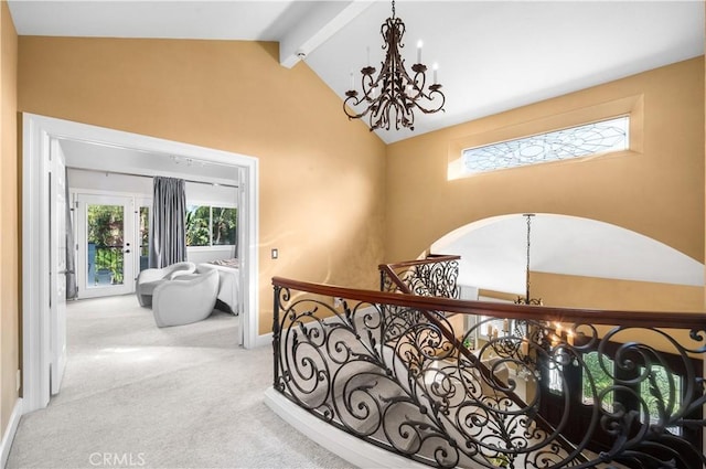 26356 Sorrell Pl, Laguna Hills, CA 92653 - hallway with a chandelier, carpet flooring, beamed ceiling, arched walkways, and high vaulted ceiling