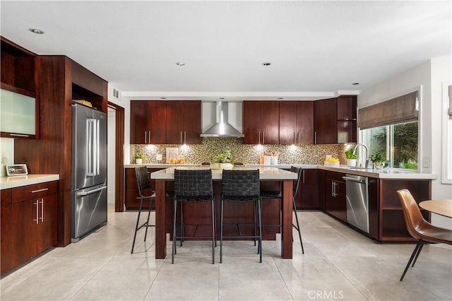 26356 Sorrell Pl, Laguna Hills, CA 92653 - kitchen with wall chimney range hood, stainless steel appliances, backsplash, a kitchen island, and light countertops