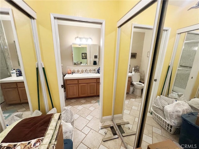 13722 Red Hill Ave Unit 15, Tustin, CA 92780 - bathroom featuring stone tile floors, vanity, and a shower stall
