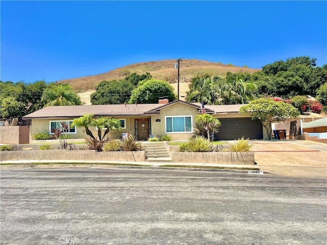 1349 Beech Hill Ave, Hacienda Heights, CA 91745 - single story home with driveway, an attached garage, stucco siding, and a chimney