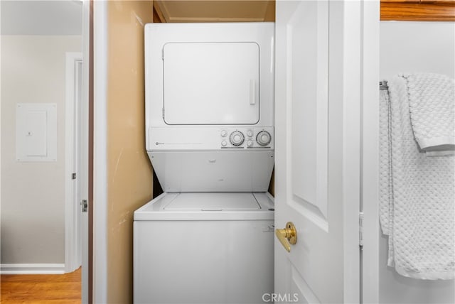 13311 Twin Hills Rd Unit 55H, Seal Beach, CA 90740 - laundry area with electric panel, stacked washing machine and dryer, and wood finished floors