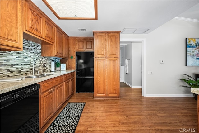 13311 Twin Hills Rd Unit 55H, Seal Beach, CA 90740 - kitchen with black appliances, backsplash, light wood-style flooring, brown cabinets, and ornamental molding