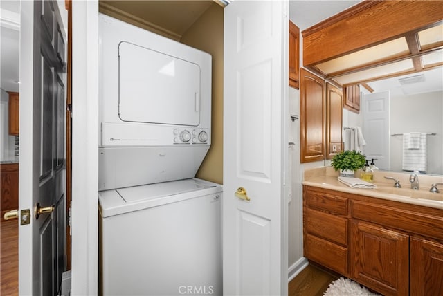 13311 Twin Hills Rd Unit 55H, Seal Beach, CA 90740 - laundry room with stacked washer / dryer and wood finished floors