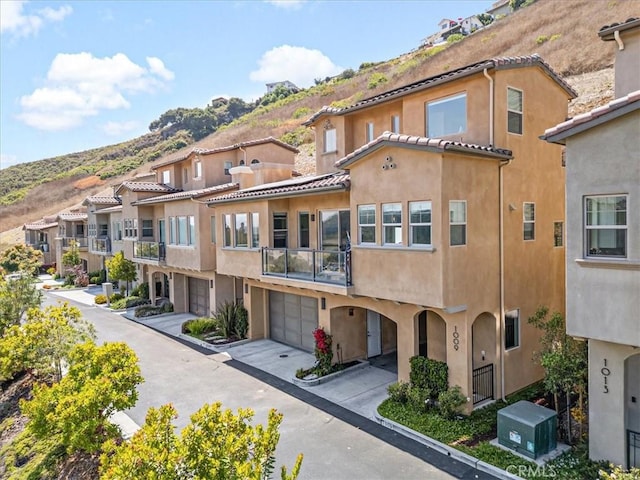 1009 Price Canyon Rd, Pismo Beach, CA 93449 - view of property featuring a mountain view, a residential view, a garage, and driveway