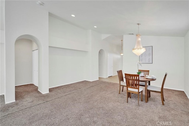 11246 Pleasant Hills Dr, Apple Valley, CA 92308 - dining space with arched walkways, carpet flooring, a chandelier, recessed lighting, and lofted ceiling