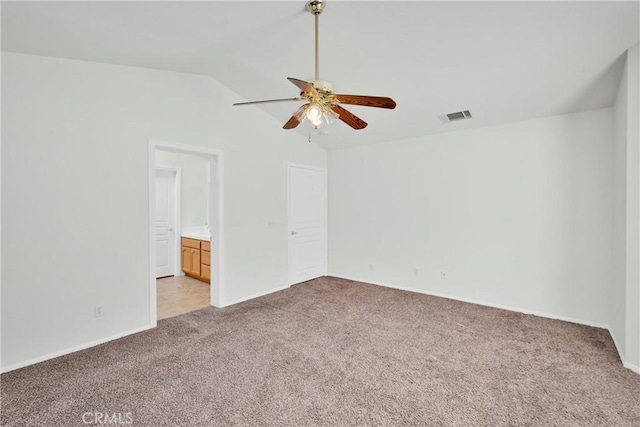 11246 Pleasant Hills Dr, Apple Valley, CA 92308 - unfurnished bedroom with light carpet, vaulted ceiling, connected bathroom, and ceiling fan