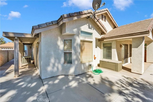11246 Pleasant Hills Dr, Apple Valley, CA 92308 - rear view of house with stucco siding, a patio area, and a tile roof