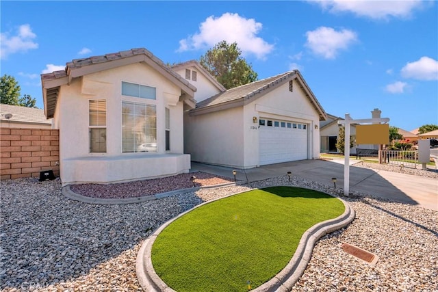 11246 Pleasant Hills Dr, Apple Valley, CA 92308 - view of front of house featuring concrete driveway, an attached garage, and stucco siding