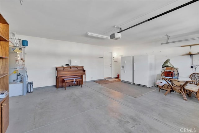 11246 Pleasant Hills Dr, Apple Valley, CA 92308 - garage with white fridge with ice dispenser, a garage door opener, freestanding refrigerator, and strapped water heater