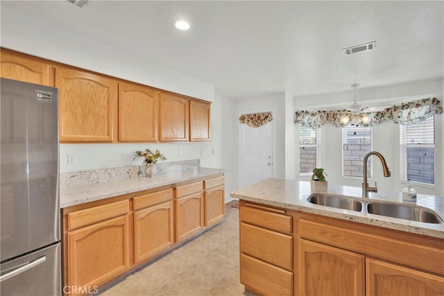 11246 Pleasant Hills Dr, Apple Valley, CA 92308 - kitchen featuring freestanding refrigerator, light stone countertops, ceiling fan, light tile patterned flooring, and recessed lighting