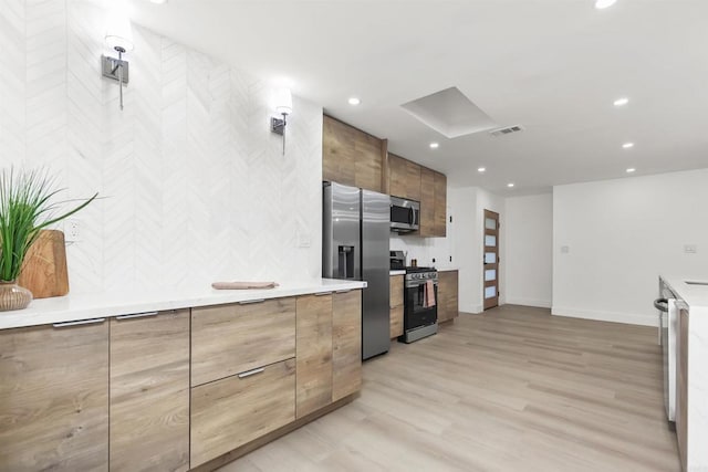 4143 Cole Way, San Diego, CA 92117 - kitchen featuring stainless steel appliances, modern cabinets, recessed lighting, light wood-style flooring, and light countertops