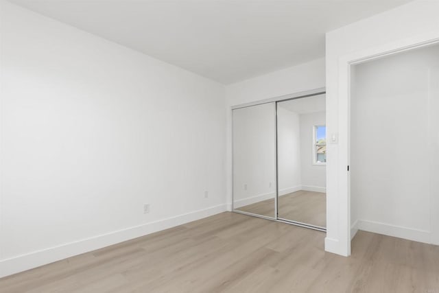 4143 Cole Way, San Diego, CA 92117 - unfurnished bedroom with light wood-type flooring and a closet