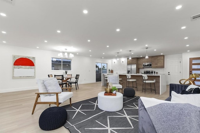 4143 Cole Way, San Diego, CA 92117 - living room with recessed lighting, light wood-style floors, and a chandelier