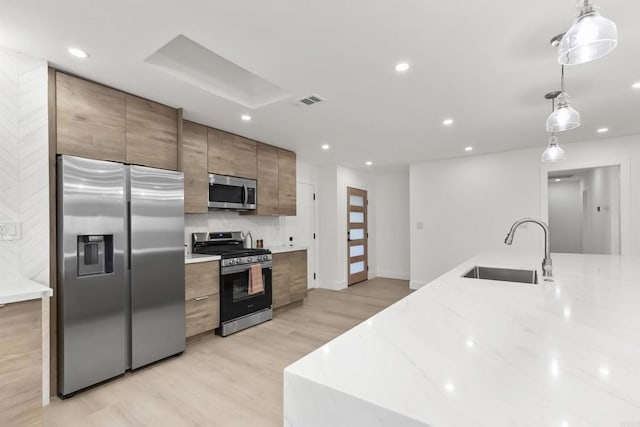 4143 Cole Way, San Diego, CA 92117 - kitchen with stainless steel appliances, light wood-style floors, light stone counters, pendant lighting, and recessed lighting
