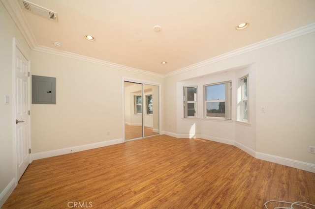 8851 Sonora Rd, Phelan, CA 92371 - unfurnished room featuring electric panel, light wood-style flooring, crown molding, healthy amount of natural light, and recessed lighting