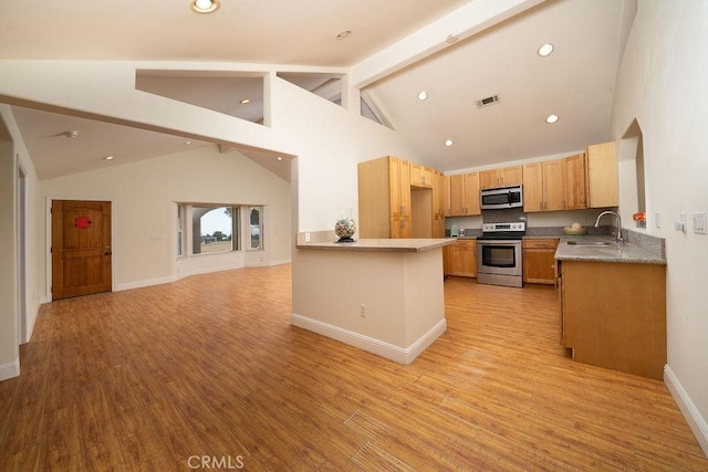8851 Sonora Rd, Phelan, CA 92371 - kitchen featuring stainless steel appliances, beam ceiling, light wood-style floors, open floor plan, and high vaulted ceiling