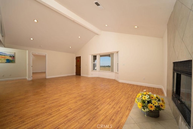 8851 Sonora Rd, Phelan, CA 92371 - unfurnished living room featuring a high end fireplace, light wood-style floors, beamed ceiling, recessed lighting, and high vaulted ceiling