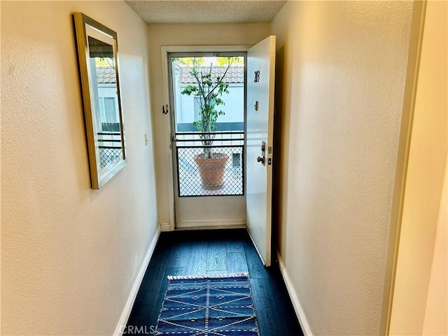 4242 Stansbury Ave Unit 203, Sherman Oaks, CA 91423 - doorway to outside with dark wood-style floors and a textured wall
