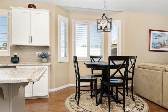 41798 Aviv Ct, Murrieta, CA 92562 - dining space with a chandelier, light wood-style flooring, and healthy amount of natural light