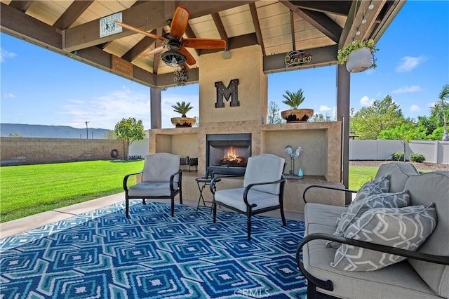 41798 Aviv Ct, Murrieta, CA 92562 - fenced backyard featuring a patio area, ceiling fan, an outdoor living space with a fireplace, and a gazebo