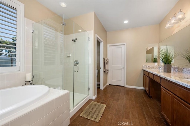 41798 Aviv Ct, Murrieta, CA 92562 - full bath featuring double vanity, a stall shower, a garden tub, and wood finished floors