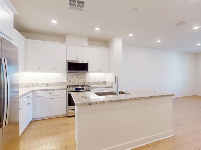 2603 Winston Ct, Arcadia, CA 91007 - kitchen with appliances with stainless steel finishes, decorative backsplash, light stone counters, white cabinets, and recessed lighting