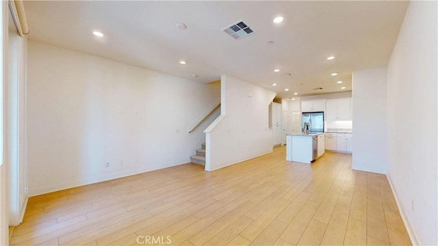2603 Winston Ct, Arcadia, CA 91007 - unfurnished living room featuring light wood-type flooring, stairs, and recessed lighting