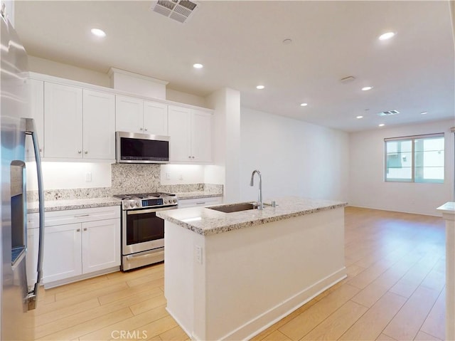 2603 Winston Ct, Arcadia, CA 91007 - kitchen with appliances with stainless steel finishes, light wood finished floors, backsplash, white cabinets, and light stone countertops
