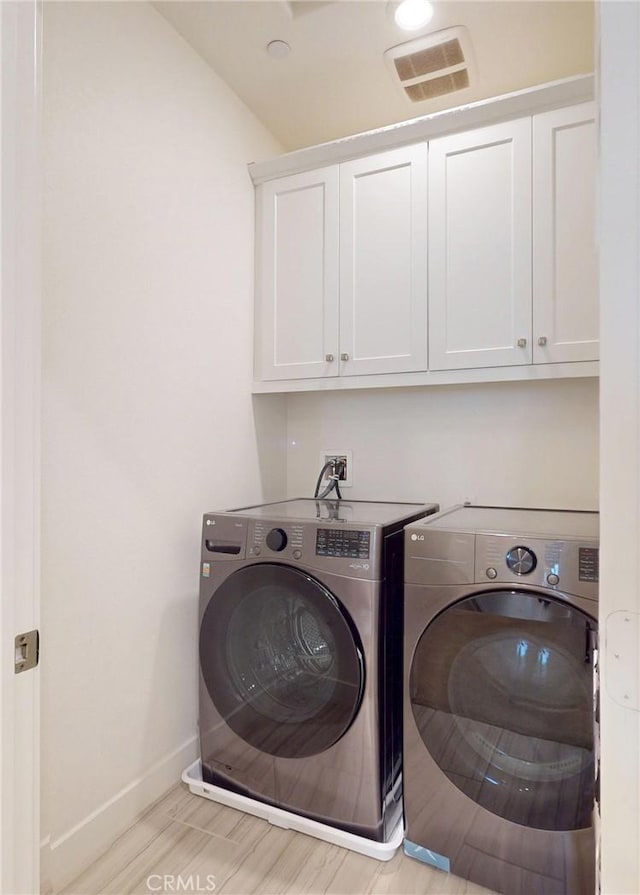 2603 Winston Ct, Arcadia, CA 91007 - laundry room with washer and clothes dryer, cabinet space, and light wood finished floors