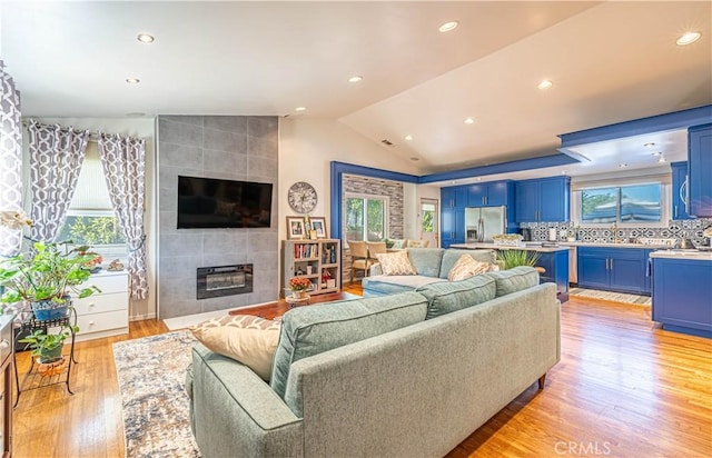 8638 Yorktown Ave, Los Angeles, CA 90045 - living area with light wood finished floors, vaulted ceiling, a fireplace, and recessed lighting