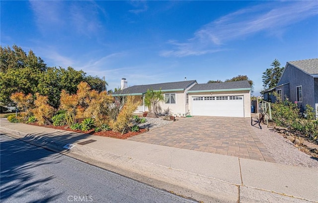 8638 Yorktown Ave, Los Angeles, CA 90045 - ranch-style home with an attached garage, decorative driveway, and stucco siding