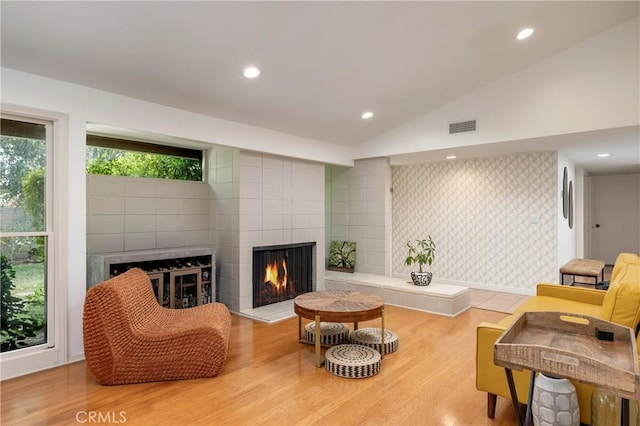 2911 Walker Lee Dr, Rossmoor, CA 90720 - living room featuring a tile fireplace, vaulted ceiling, wood finished floors, and recessed lighting