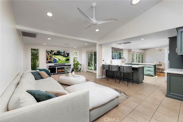 2911 Walker Lee Dr, Rossmoor, CA 90720 - living area featuring a lit fireplace, vaulted ceiling, recessed lighting, a ceiling fan, and light tile patterned floors