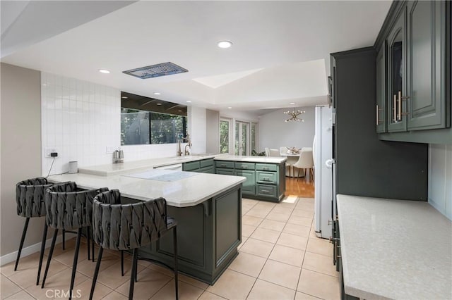 2911 Walker Lee Dr, Rossmoor, CA 90720 - kitchen featuring a peninsula, light countertops, light tile patterned floors, recessed lighting, and a chandelier