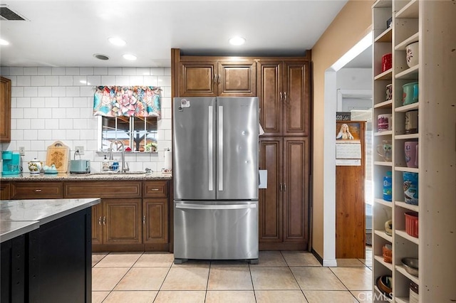 117 N Morada Ave, West Covina, CA 91790 - kitchen featuring freestanding refrigerator, light tile patterned floors, tasteful backsplash, and light stone countertops
