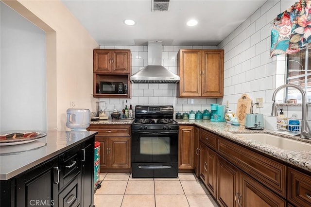 117 N Morada Ave, West Covina, CA 91790 - kitchen with wall chimney range hood, black appliances, light tile patterned floors, brown cabinetry, and tasteful backsplash