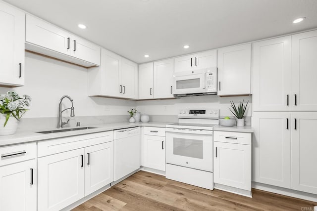 4514 Dawson Ave Unit 2, San Diego, CA 92115 - kitchen featuring white appliances, light countertops, white cabinetry, recessed lighting, and light wood-style flooring