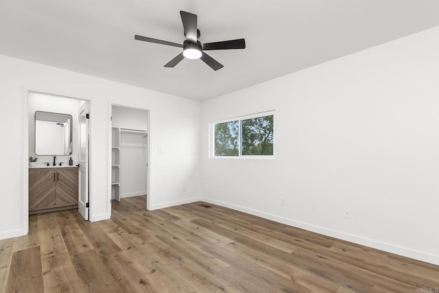 4514 Dawson Ave Unit 4, San Diego, CA 92115 - unfurnished bedroom featuring wood finished floors, a spacious closet, ensuite bathroom, and ceiling fan