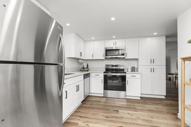 4514 Dawson Ave Unit 4, San Diego, CA 92115 - kitchen with stainless steel appliances, light wood-type flooring, light countertops, white cabinetry, and recessed lighting