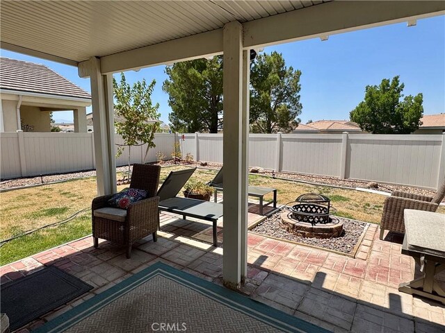 19642 Castle Harbor Ct, Apple Valley, CA 92308 - fenced backyard with an outdoor fire pit and a patio area