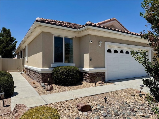 19642 Castle Harbor Ct, Apple Valley, CA 92308 - mediterranean / spanish-style home with an attached garage, stucco siding, and stone siding
