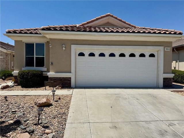 19642 Castle Harbor Ct, Apple Valley, CA 92308 - mediterranean / spanish home with driveway, an attached garage, a tiled roof, and stucco siding