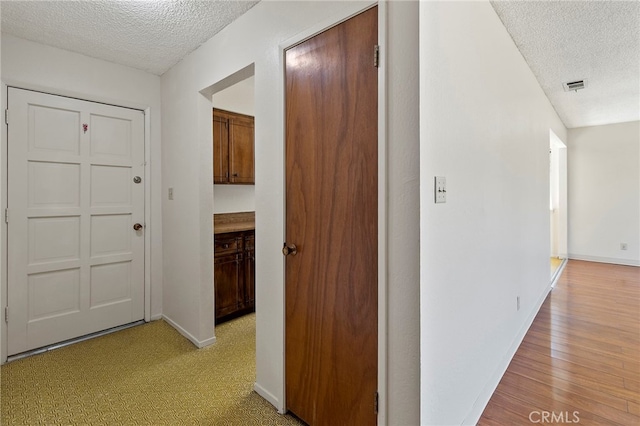 2151 W Pico Ave, Fresno, CA 93705 - hall featuring a textured ceiling and light wood-style flooring