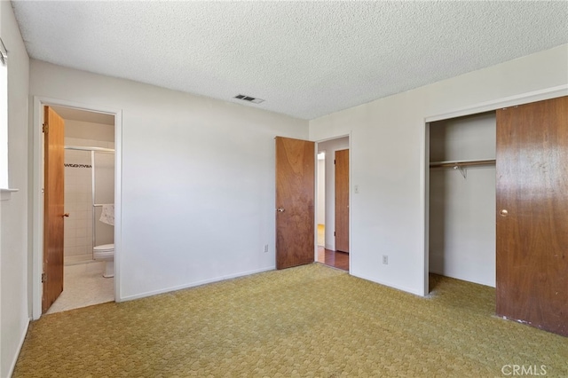 2151 W Pico Ave, Fresno, CA 93705 - unfurnished bedroom featuring a closet, ensuite bathroom, a textured ceiling, and carpet flooring