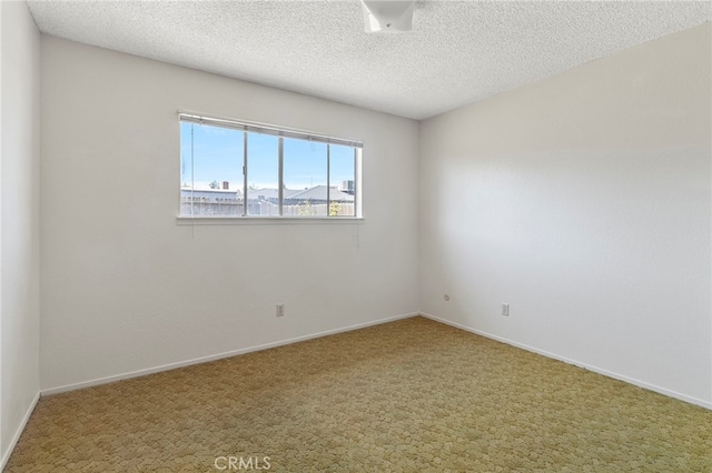 2151 W Pico Ave, Fresno, CA 93705 - carpeted empty room featuring a textured ceiling and baseboards