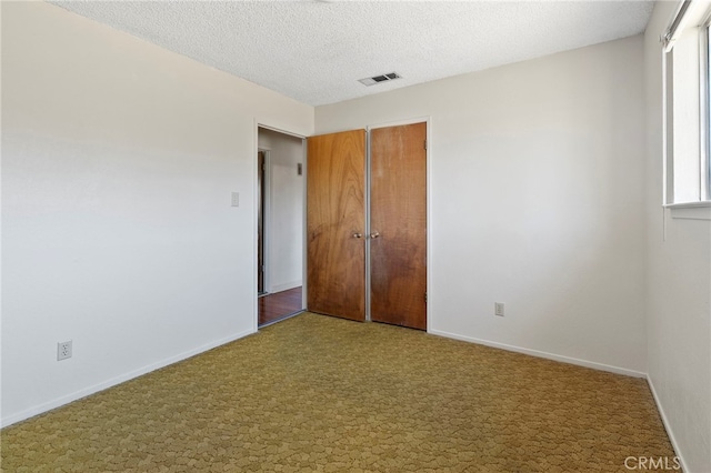 2151 W Pico Ave, Fresno, CA 93705 - unfurnished bedroom with carpet, a closet, and a textured ceiling