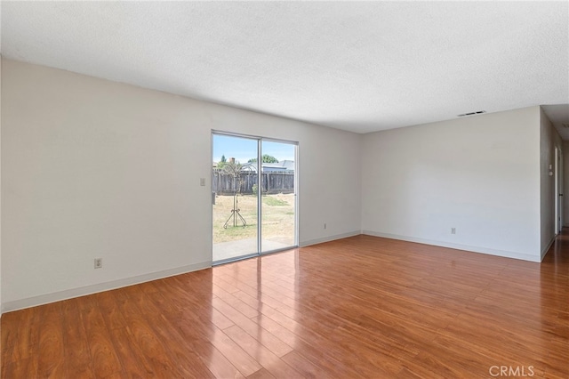 2151 W Pico Ave, Fresno, CA 93705 - spare room featuring wood finished floors and a textured ceiling